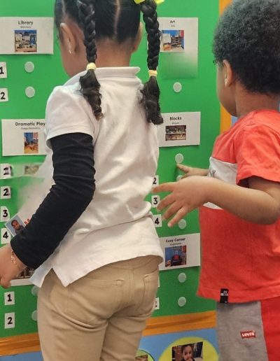 Two children during a center time activity at Luminous.