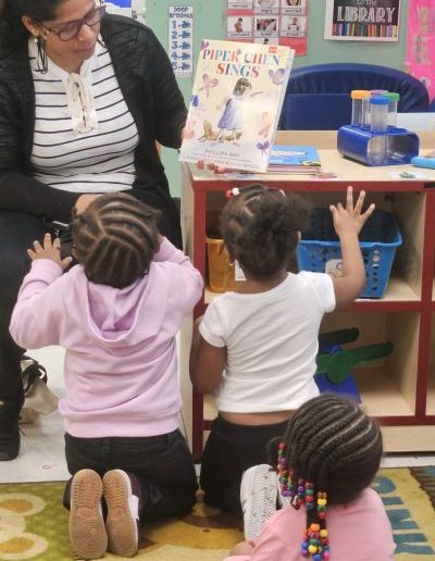 Children react to a book during Read for the Record at Luminous.